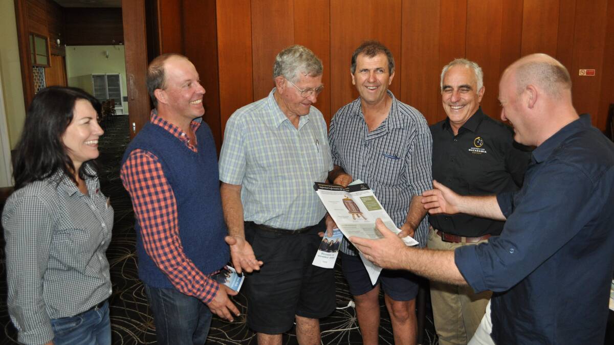 HIGH HOPES FOR HARVEST: Corrine Jasper, left, and Jolyon Burnett (second from right) with Nambucca Valley macadamia growers Charlie Higgins, Paul Tollis, Tony Styles and Hugh Harris