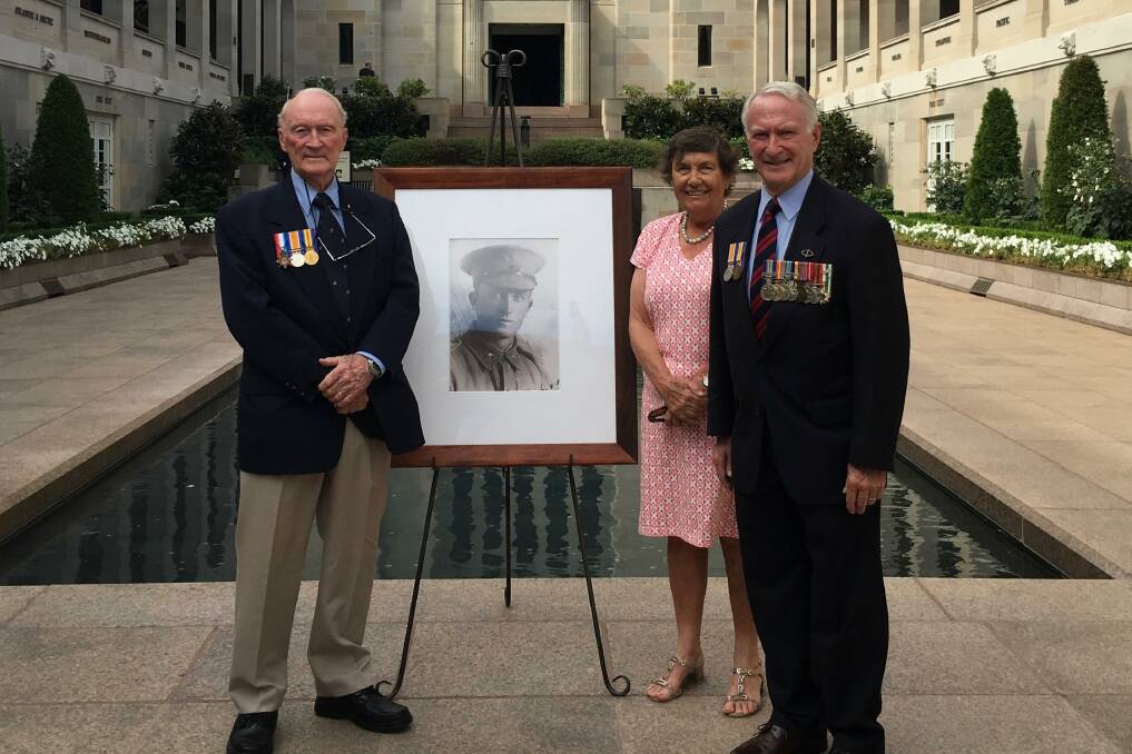 At the Australian War Memorial in Canberra: Phil Wilkins, Helen Heath and David Wilkins before the photograph of their uncle, Philip Wilkins, shot and killed on the Western Front a century before in World War I.