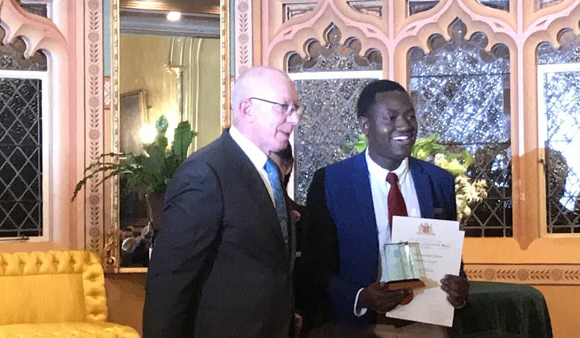 Governor Hurley presented Linus with a trophy and certificate as International Student of the Year at Government House