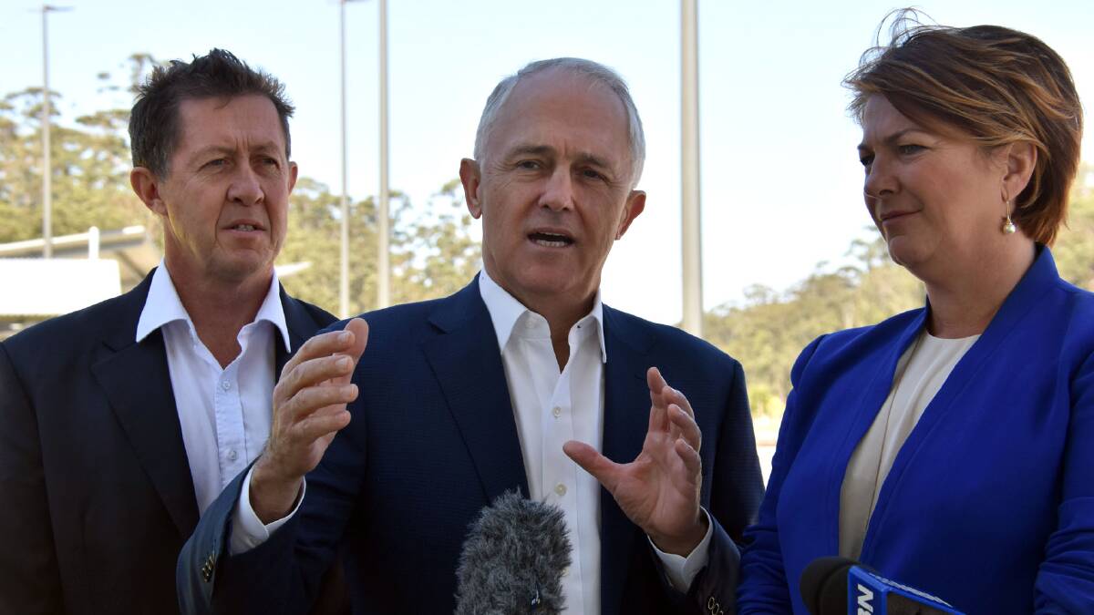 Prime Minister Malcolm Turnbull (centre) speaks about progress on the Pacific Highway upgrade, flanked by Cowper MP Luke Hartsuyker and NSW Roads Minister Melinda Pavey.