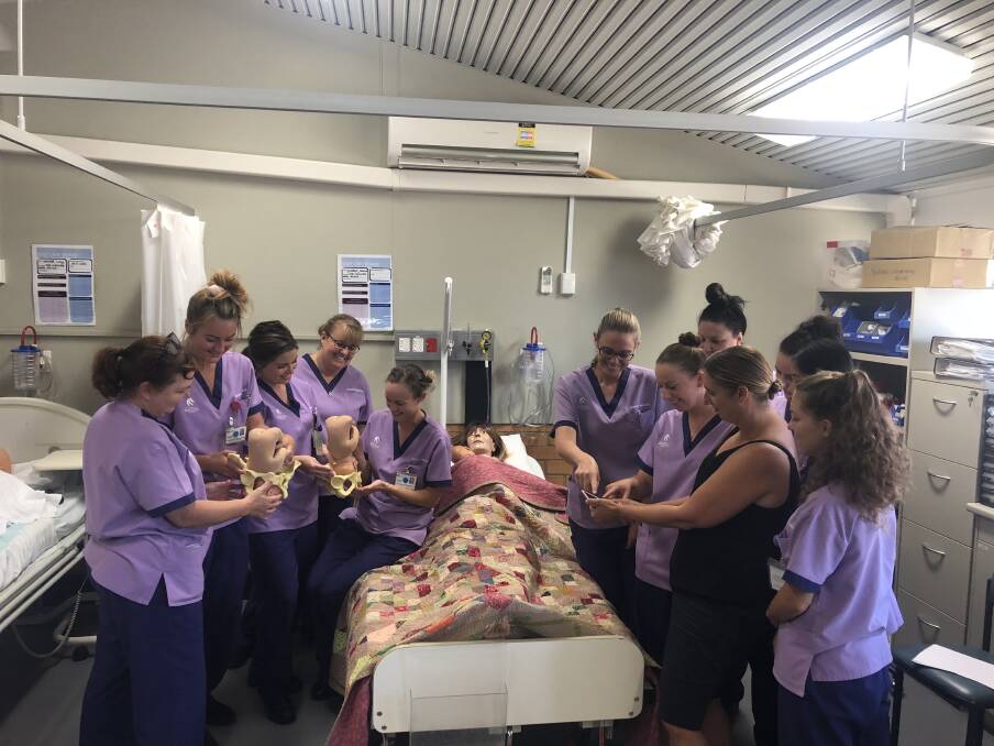 Groundbreaking technology: Midwifery lecturer Shanna Fealy shows the Road to Birth application to third year Bachelor of Midwifery students Arlene Lavilla, Erica Bell, Felicity Lavers, Maddie Hoysted, Alyssa Hay, Annette Stace, Kylie Ashton, Ebony Jennings, April Collins and Courtney Haydon.