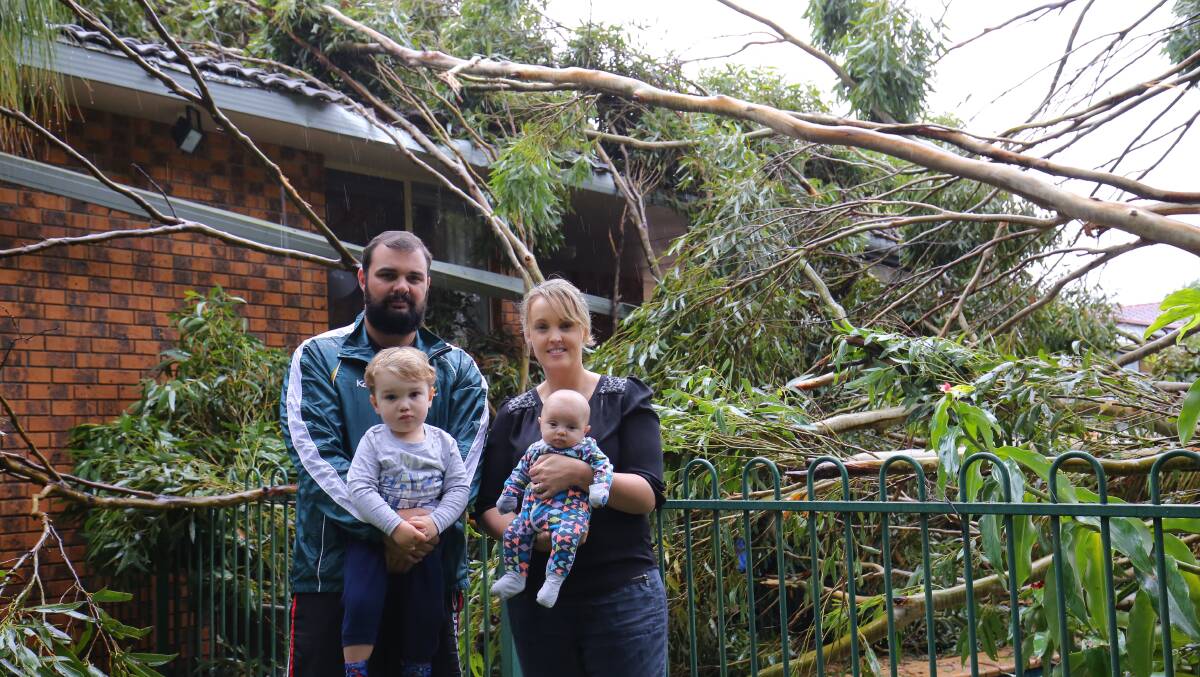 All safe: Steve and Sally Tonkin, with their children Jack and Emilia, after a tree fell on their home.