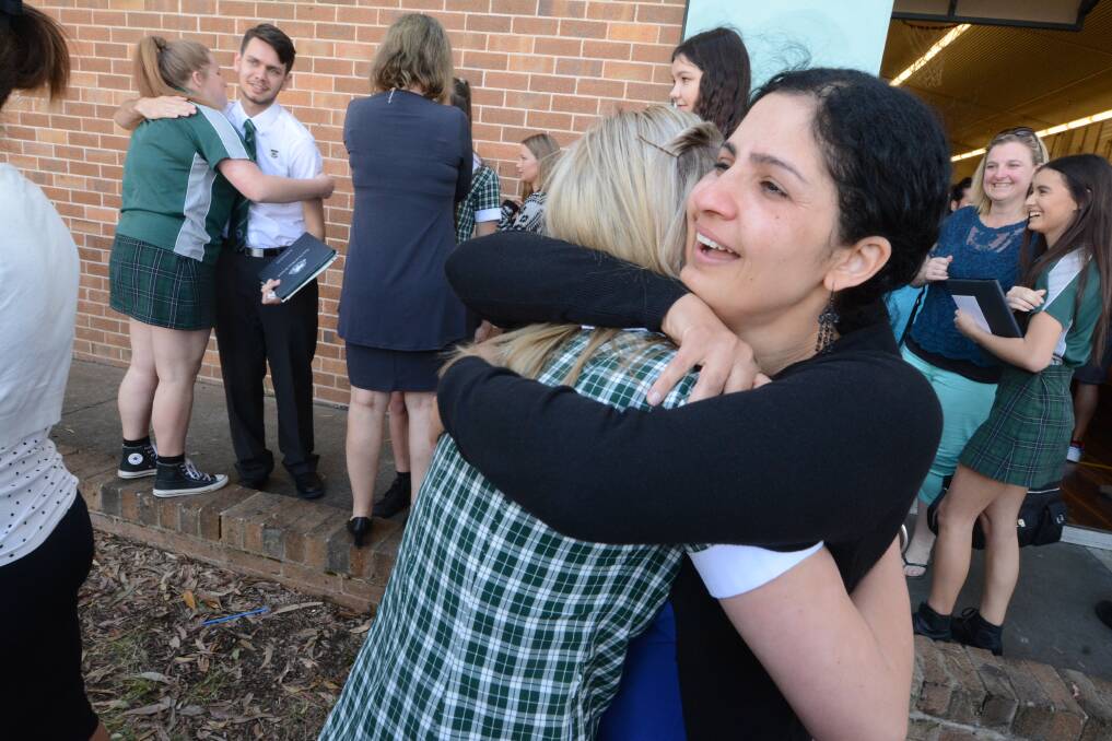 Hugs and tears: Year 12 advisor Mrs Joon's affection for her students was evident.  "For me, my kids are you," she wrote in a poem she created for her students. Photo: Scott Calvin.