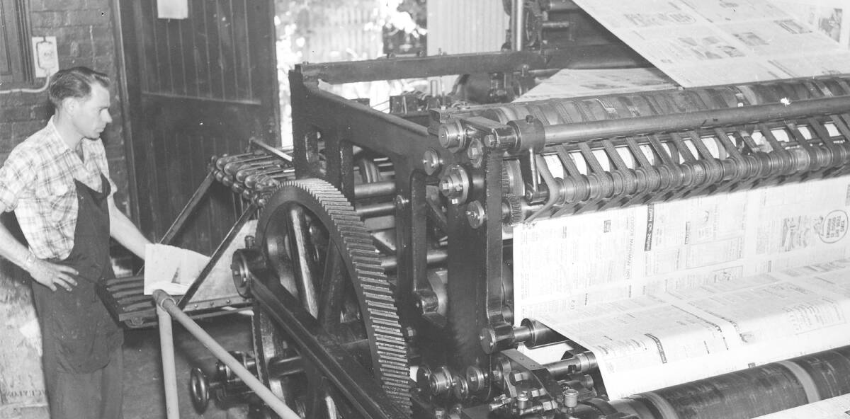 Swiss precision: John Doust with the machine, which was imported from Switzerland and could print, cut and fold, that was still in use until the mid 1970s when the paper moved offsite to be printed.