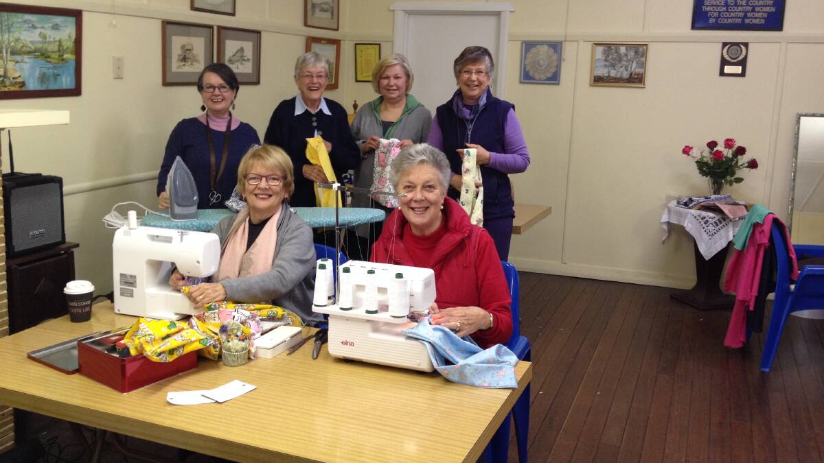 Book buddies making borrow bags: Gwyneth and Thellie (front), and Katherine, Janet, Kaye and Fiona (back), doing their bit to save Wingham from plastic. 

