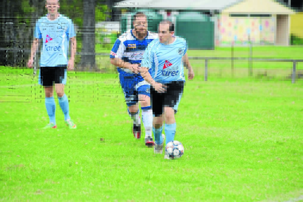 Brad Thompson starts an attacking raise for Taree in the clash against Macleay Valley at Omaru Park. The Wildcats meet Port FC on Saturday at Port Macquarie.