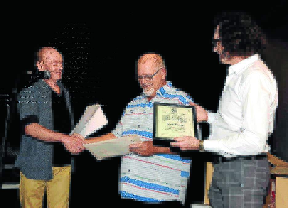President of Taree Arts Council Bruce Wiseman (left) and vice president Paul Eade (right) present John Holme with life membership of Taree Arts Council.