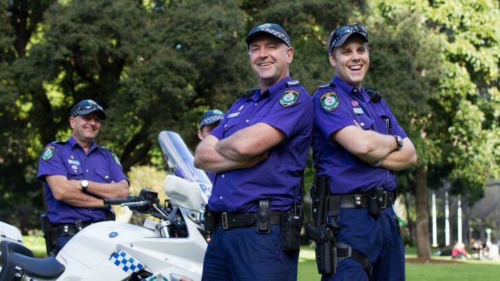 Senior Constable Craig Parkinson, Senior Constable Andrew Hodgson, and Constable Jarryd De Castro wear purple in Hyde Park to celebrate Wear It Purple Day. Photo: Janie Barrett 