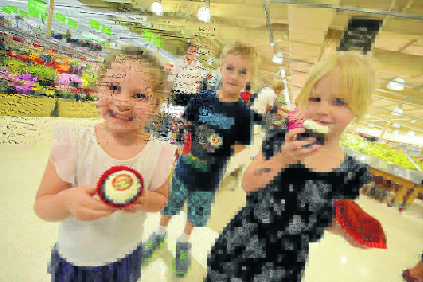 Layla Robards, Lachlan Hunter and Bianka Hunter with cup cakes marking Coles centenary.