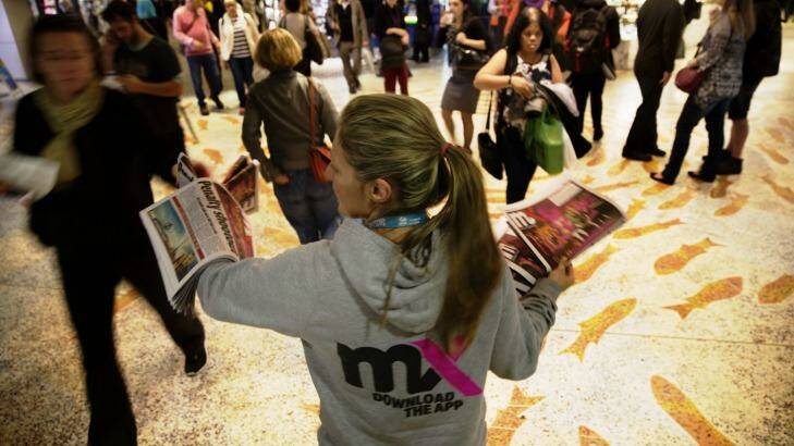 <i>mX</i> newspapers are handed out to
commuters at Sydney Town Hall on Thursday. Photo: Shu Yeung
