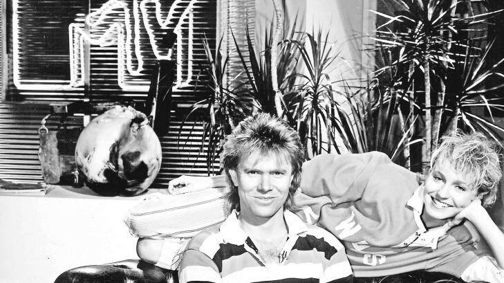 Richard Wilkins, his hair, and Joy Smithers on the set of Channel Nine's MTV in the 1980s. Photo: Sydney Morning Herald