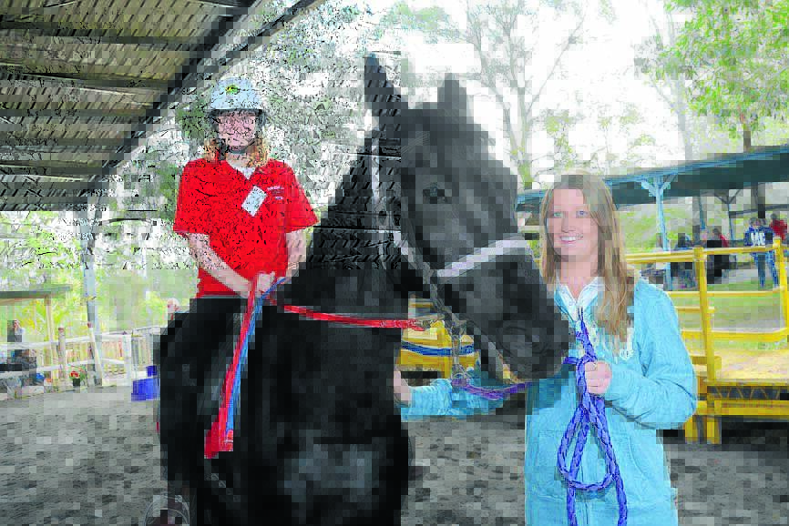 Sophie Robinson with volunteer Kirstie Appleby at the Manning Great Lakes Riding for the Disabled Association (NSW)'s regional mounting games at Rainbow Flat.