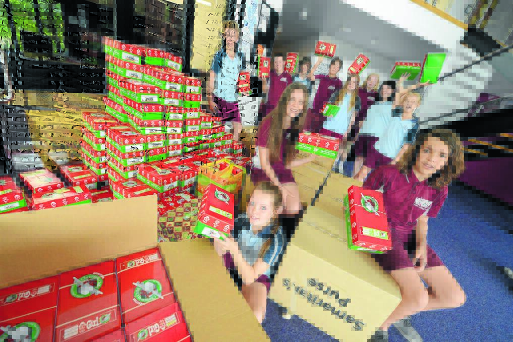 Jessie Wright, Tedeisha Heaslip and Dylan Paulson hold shoeboxes filled with gifts for children living in extremely poor communities throughout the world. They were part of a group of Taree Christian College students who worked together to help pack the Operation Christmas Child boxes. Also pictured is Jesse Clarkson, Jarrad Knox, Matthew Locke, Bailey Watson, Courtney Morgan, Hayley Hayward and Kaitlin Reeman.