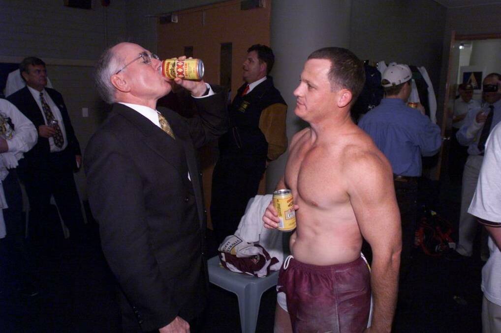 John Howard downing a tinny with Brisbane Broncos player Kevin Walters after their grand final win in 1998. Photo: Andrew Meares