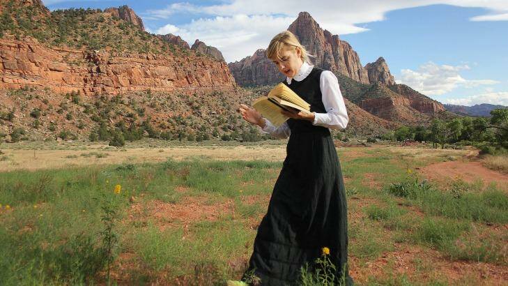 Sophia Hewson reads to mountains called the Court of the Patriarchs in Utah as research for her exhibition.  Photo: Jason Flower
