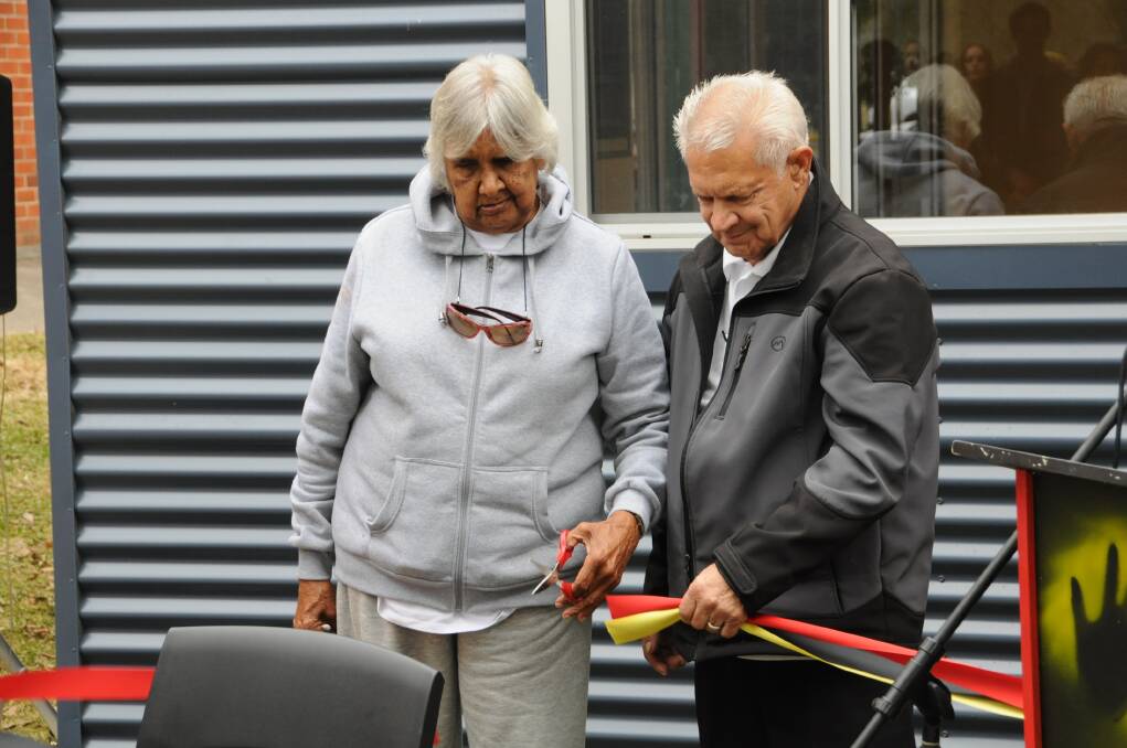 Elders Melva Clarke and Dave Russell cut the ribbon officially opening Taree High's Aboriginal resource centre 'Ngarralbaa'.