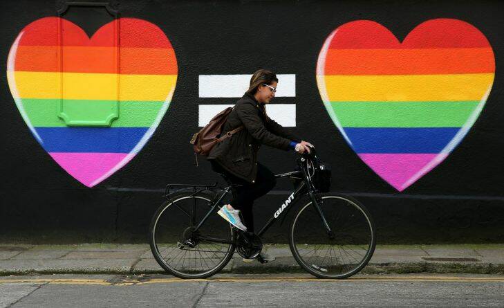 A woman cycles past a marriage equality mural in the Liberties area of Dublin, as Ireland should become the international advocate for gay rights, a key figure in spearheading the country's vote for same-sex marriage has said.. Picture date: Sunday May 24, 2015. On the back of the resounding yes for gay marriage - 1.2 million Irish voters backed it - attention is now turning to when the first ceremonies will take place. See PA story IRISH GayMarriage. Photo credit should read: Brian Lawless/PA Wire .