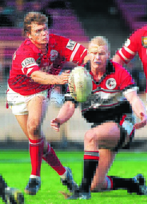 Michael Buettner offloads during his days with the North Sydney Bears. He'll play with the Taree City Bulls tomorrow against Wingham at the Jack Neal Oval.