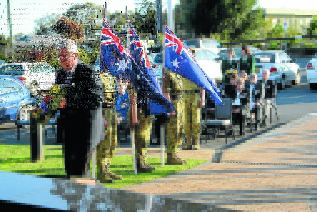 Mayor Paul Hogan lays a wreath at the ceremony marking the 49th anniversary of the Battle of Long Tan, at the Club Taree memorial this week.