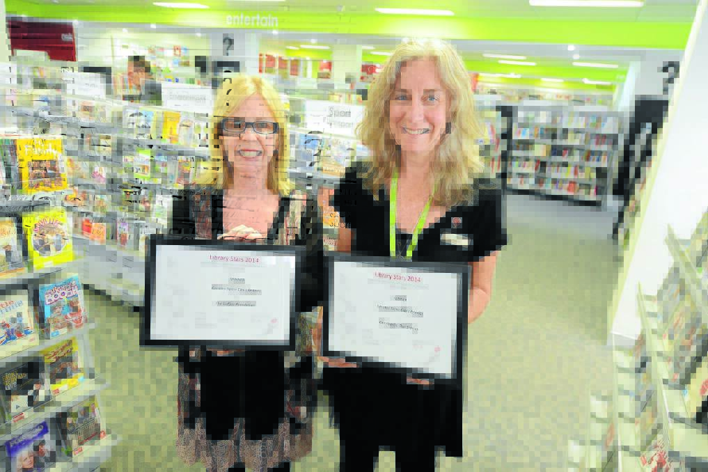 Greater Taree City Council's senior leader cultural services, Margie Kirkness and community outreach librarian Debbie Horgan with awards picked up at the recent Library Stars 2014 forum.