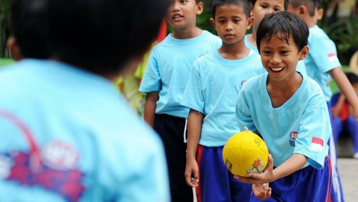 Students play Aussie Rules at an elementary school in Jakarta. Photo: Jefri Tarigan