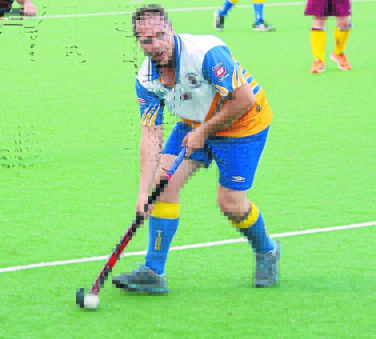 Phil Baker from Tigers playing in last season;s Manning A-grade hockey grand final against Chatham. Port Macquarie teams could be added to the competition in 2016.