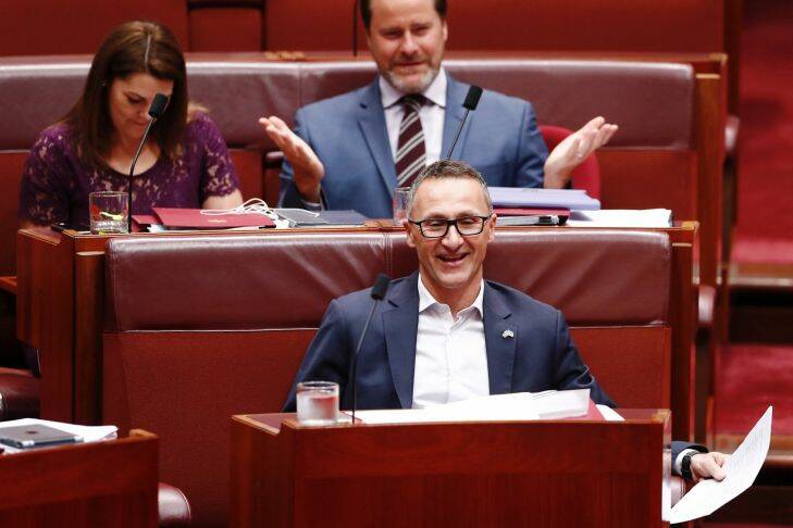 Senator Richard Di Natale smiles as Attorney-General Senator George Brandis correctly pronounces his name during Question Time in the Senate at Parliament House in Canberra on Thursday 19 October 2017. fedpol Photo: Alex Ellinghausen 