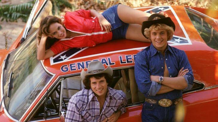 <i>Dukes of Hazzard</i> castmembers Tom Wopat, John Schneider and Catherine Bach with the now contentions General Lee. Photo: Supplied
