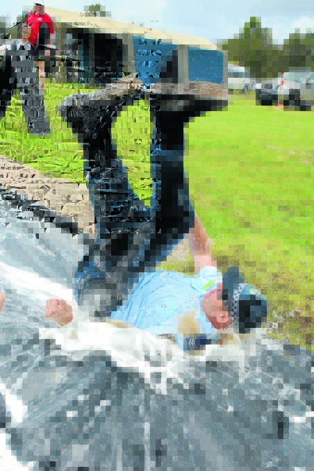 Slippin' and slidin': Sargeant Matthew Price was a great sport, and got in on the Slip and Slide with the water provided by Tinonee Fire Brigade.