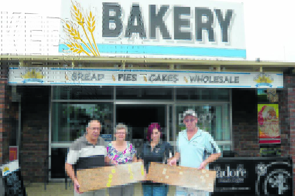 Allan Eyb and Margaret Love from Cundletown Museum and Tracey and Cameron Potts, owners of the bakery, with the two signs.