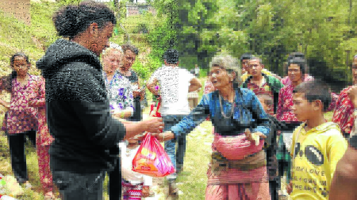 Prakash and Jessica Bistga handing out food and basic needs to the people of Nepal.