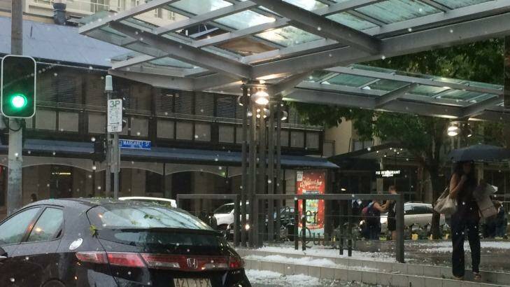 Panels of glass shatter on the corner of Margaret Street in the city. Photo: Amy Remeikis