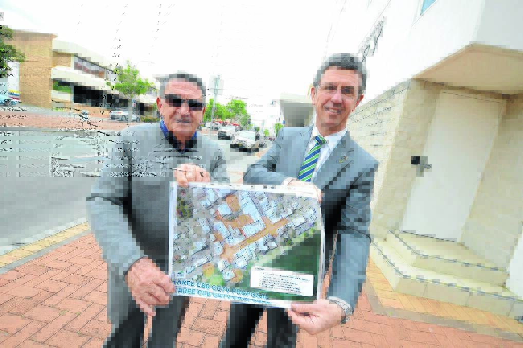 A safer CBD: Taree Rotarian Ken Patterson and federal MP David Gillespie with plans for the Taree CBD CCTV project.