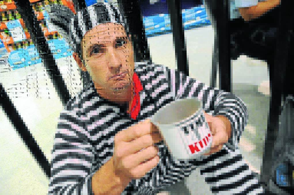 Rattling his tin: Westpac Bank manager, Tim Woodhill in the Time 4 Kids cells.