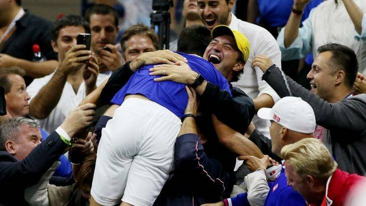 Jumping for joy: Novak Djokovic rejoices with his entourage. Photo: Matthew Stockman