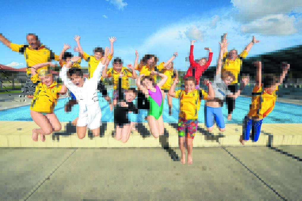 Taree Swimming Club members celebrate the news the Country Regional Carnival will be held here next January. Pictured are (back from left):	Mark Dew, Bevan Smith, Jordan Smith, Keira Bosher, Jade Page, Olivia Dew, Shyanne Gregan and Wendy Bosher. Front: Jasmine Jackson, Brady Cross, Bailey Wilson, Tasmin Gregan, Georgia Bosher, Tobias Gregan and Marcus Smith.