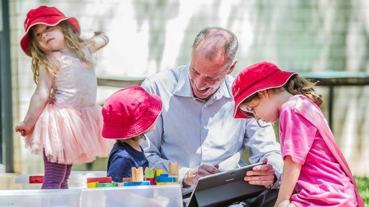 Professor Tom Lowrie of the University of Canberra's STEM Education Research Centre plays with children from the Wiradjuri Pre-school. Photo: Karleen Minney