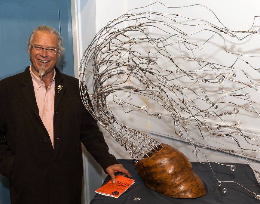H Fish with his sculpture, Wind in the Willows, which placed second in the 3-D art section.