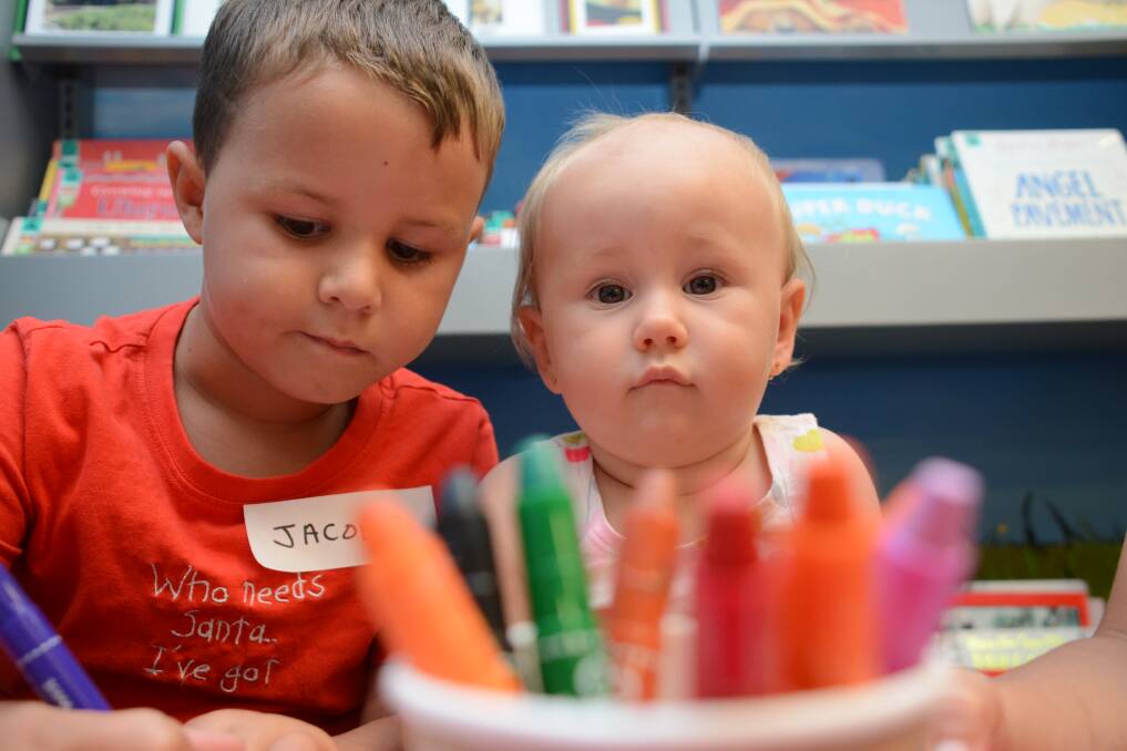 Jacobie Howard and Shaniqua McDonald colour in at a past Taree Library event. 