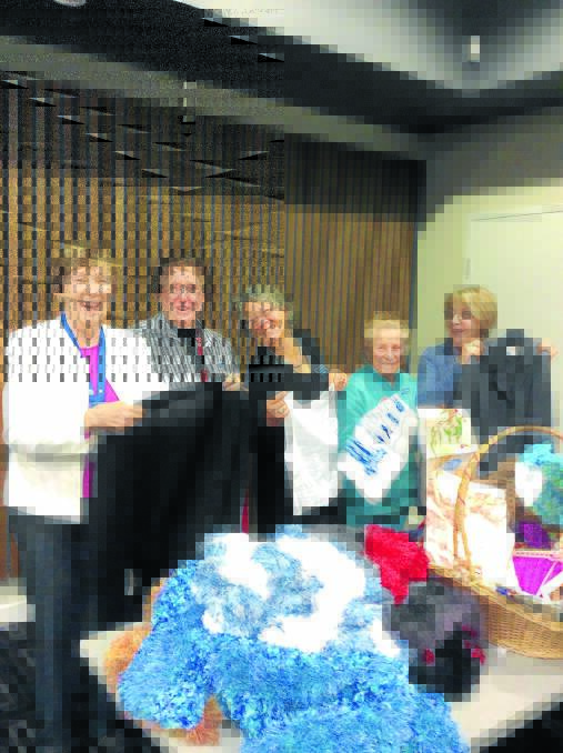 Taree Quotarians Margaret MacLean, Margaret Allison, president Trish Webber, Joy Davy and Cathy Baker sort items for sale at the upcoming garage sale.