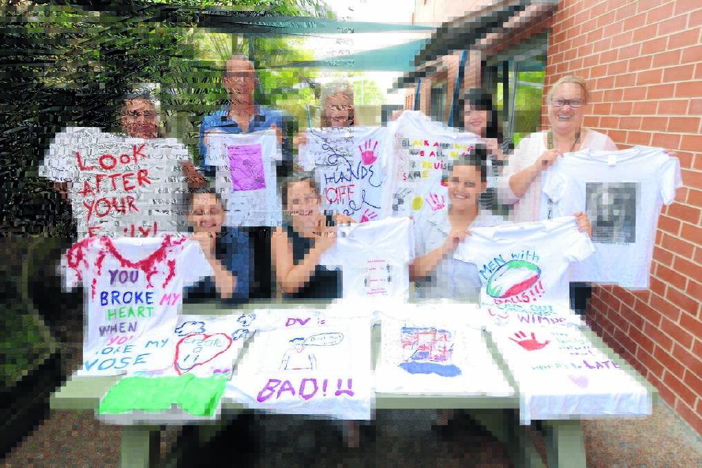 Taree Community Health staff with just an example of the white t-shirt artworks that will be displayed across the Manning as part of the Airing our Dirty Laundry campaign. Pictured are Michelle Wilkes, Ian Reece, Shannon Anima, Adrienne Greene, Jane Wallace, Karen Redgrave, Cristen Brown and Brogan Taylor.
