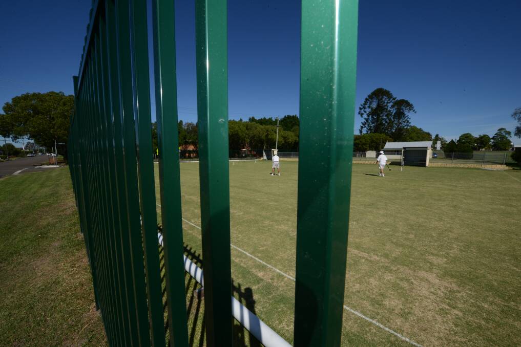 For security: Daniel Blanch is part of the team erecting the fence which will encompass the grandstand at Johnny Martin Oval, at Taree Park.