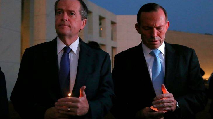 Opposition Leader Bill Shorten and Prime Minister Tony Abbott during a candlelight vigil for Andrew Chan and Myuran Sukumaran on the forecourt of Parliament House in Canberra on Thursday. Photo: Alex Ellinghausen
