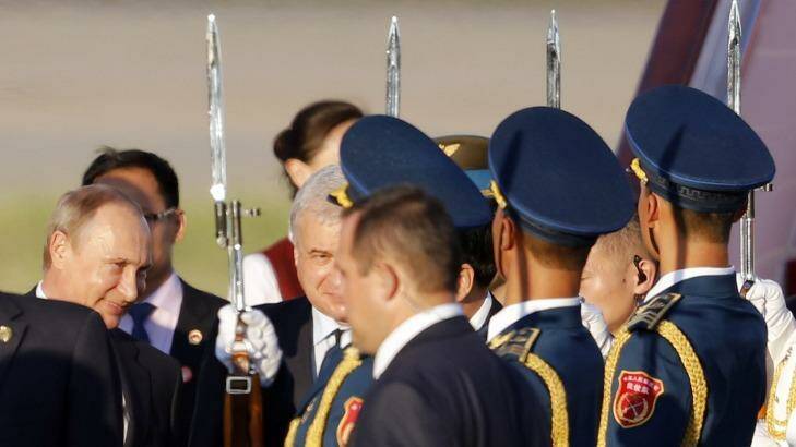 Russian President Vladimir Putin, left, arrives at the Beijing Capital International Airport in Beijing on Wednesday. Photo: Ng Han Guan