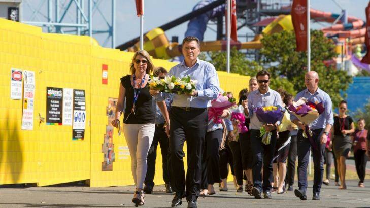 Dreamworld CEO Craig Davidson and his employers laid flowers at the theme park on Wednesday. Photo: Glenn Hunt