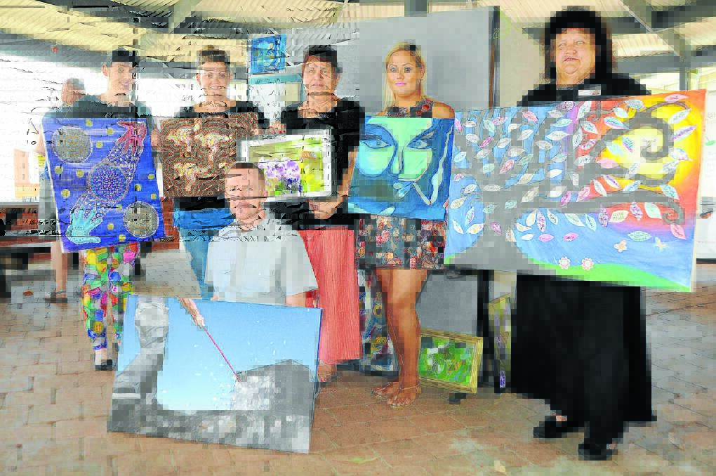 Taree TAFE Certificate IV Mental Health students Meaghan Boad, Emma Lakeman,Chris Moore, Lindy McDonald, Karley Alchin and Linda Lee display the art work of people in the community living with a mental illness.