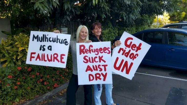 Strong views ... Vuga, left, and a friend with placards for their "counter-protest". Photo: Facebook