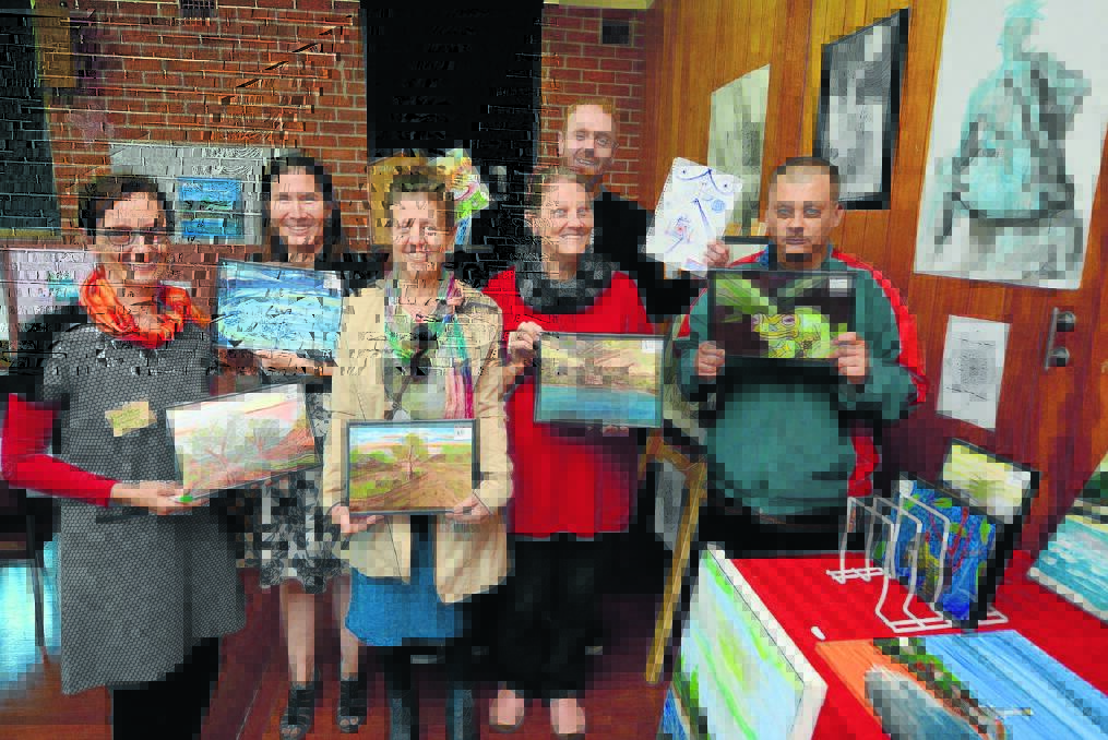 Event co-ordinator Kirsten Olsen, Elizabeth Kempers, Linda Chudy, Carol Williams, Timothy Douglas McLean and Kane Holman show some of the artwork on display at Brushes with Life.