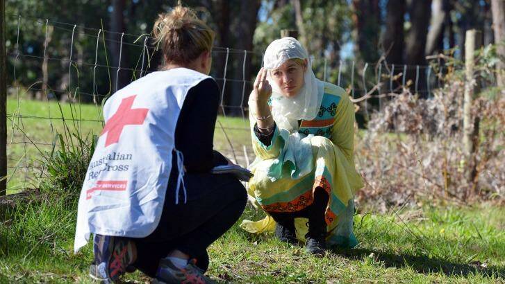 Helping hand. An aid worker and a "refugee" at a Red Cross hostile environment training camp in Yellingbo, east of Melbourne. Photo: Joe Armao