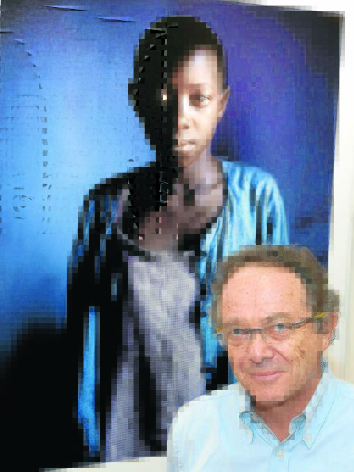 Brisbane-based photographer Eric Victor stands next to Portrait of a young girl village  Uganda 1998. Ashley Cleaver photo.
